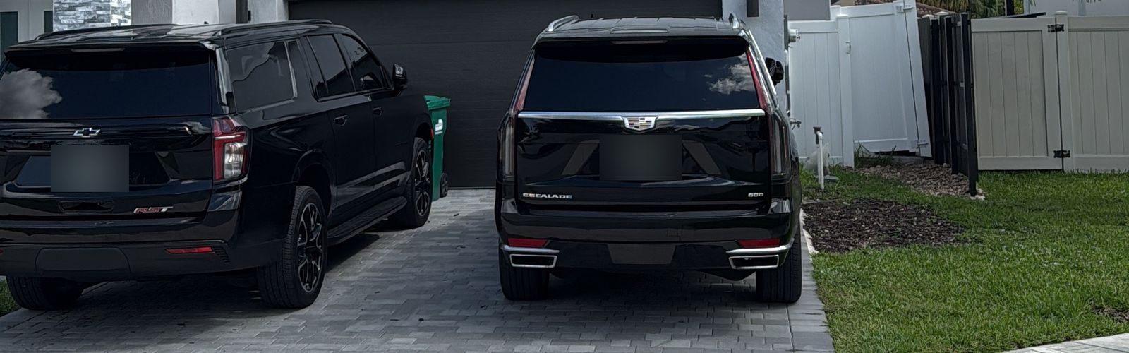 2024 Chevrolet Suburban and 2024 Cadillac Escalade, black